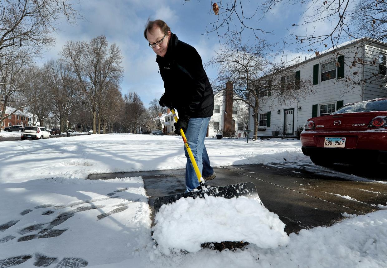 Bob Chantome cleans the snow off his driveway on South Glenwood Avenue on Friday, March 11, 2022.