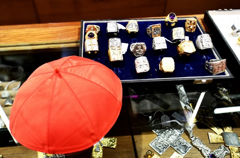 A cardinal skullcap sits next to religious rings at the workshop of Italian tailor Raniero Mancinelli, near the Vatican City