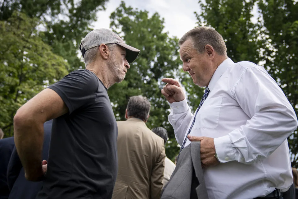 Jon Stewart in an exchange with Sen. Jon Tester, D-Mont., on Capitol Hill.