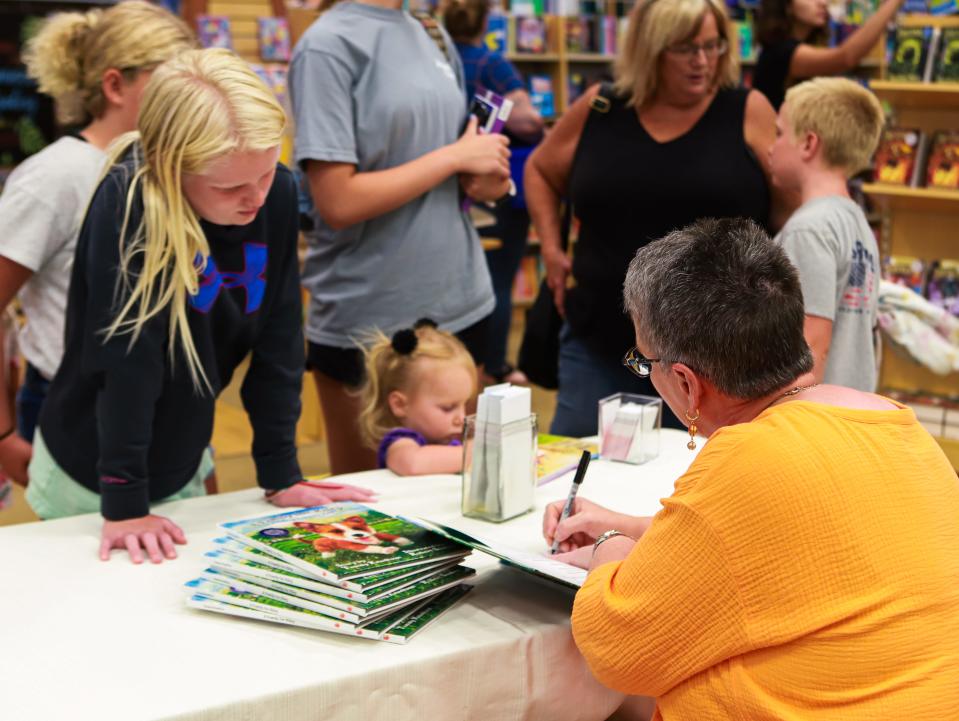 Tammy Knutson signs her new book, "A Family for Riley," at an event on Saturday, August 6, at Barnes & Noble in Sioux Falls.
