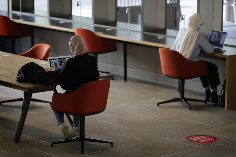 Students socially distance at desks at UCL (University College London) in London, Thursday, Sept. 17, 2020. The university is preparing its return to campus COVID-19 measures. (AP Photo/Kirsty Wigglesworth)