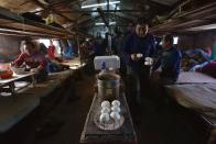 Workers have lunch in their dormitory as they take a break from building ice sculptures ahead of the 30th Harbin Ice and Snow Festival, in Harbin, Heilongjiang province December 27, 2013. According to the festival organizers, nearly 10,000 workers were employed to build the ice and snow sculptures, which require about 180,000 square metres of ice and 150,000 square metres of snow. The festival kicks off on January 5, 2014. REUTERS/Sheng Li (CHINA - Tags: ENVIRONMENT SOCIETY BUSINESS EMPLOYMENT TRAVEL FOOD) CHINA OUT. NO COMMERCIAL OR EDITORIAL SALES IN CHINA