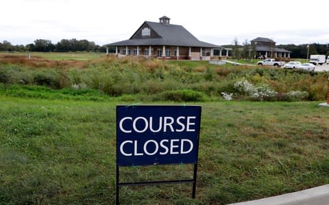 A course closed sign sits in front of the Coldwater Golf Links course - Credit:  Charlie Neibergall/AP