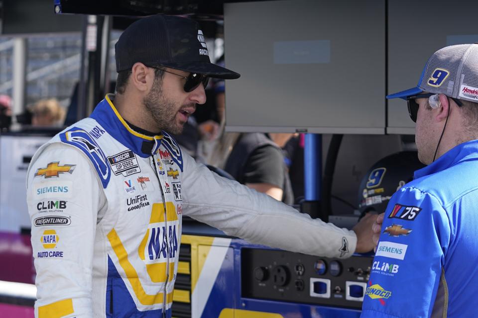 Chase Elliott talks with a crew member before a practice session for the NASCAR Cup Series auto race at Indianapolis Motor Speedway, Saturday, Aug. 12, 2023, in Indianapolis. (AP Photo/Darron Cummings)