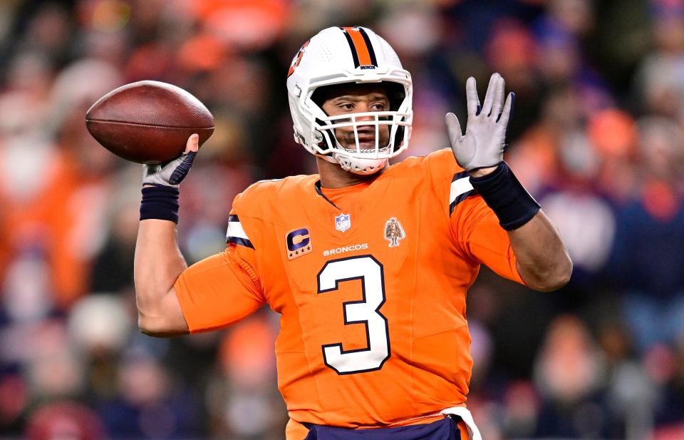 Russell Wilson throws a pass against the Patriots during a game at Empower Field at Mile High on Dec. 24, 2023.