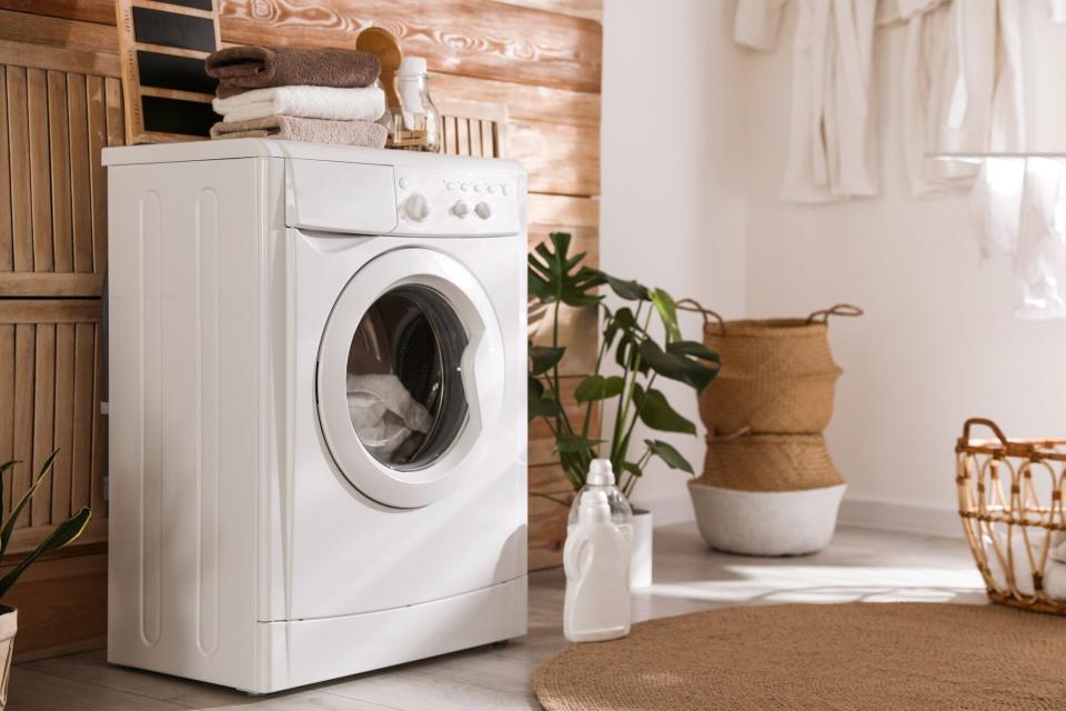 Stylish room interior with front-loading washing machine.