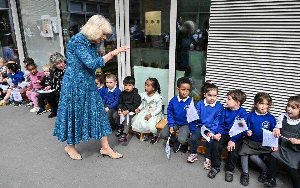 The Queen is greeted by pupils in the courtyard