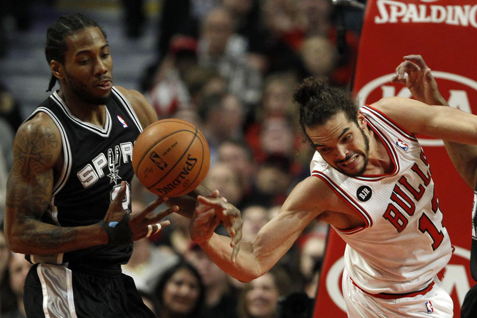 Chicago Bulls center Joakim Noah, right, loses the ball to San Antonio Spurs small forward Kawhi Leonard (2) during the first half of an NBA basketball game on Tuesday, March 11, 2014, in Chicago. (AP Photo/Andrew A. Nelles)