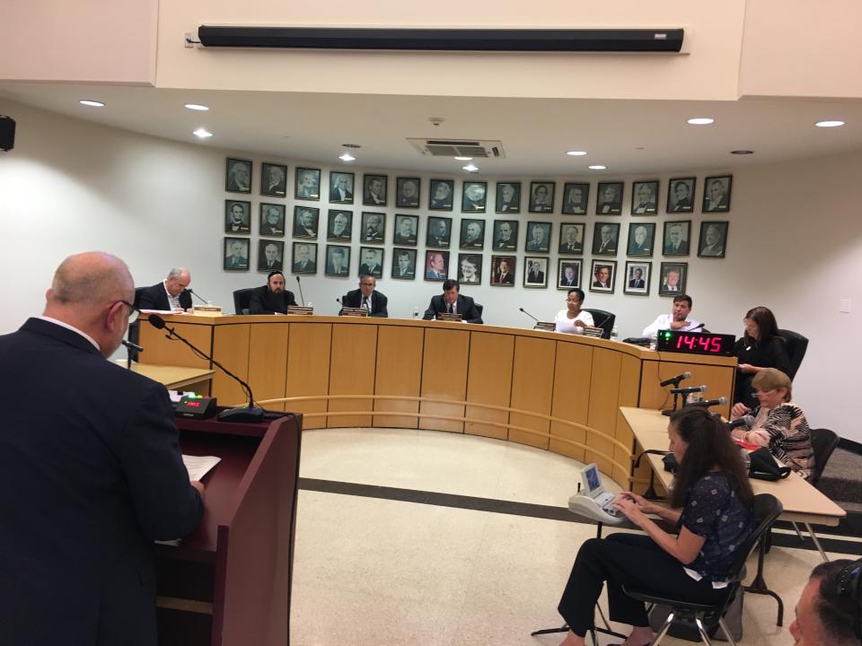 Ramapo Town Board, attorney Dennis Lynch, far left, and deputy town clerk, Maureen Pehush, far right, at Pascack Ridge public hearing Aug. 15, 2019.