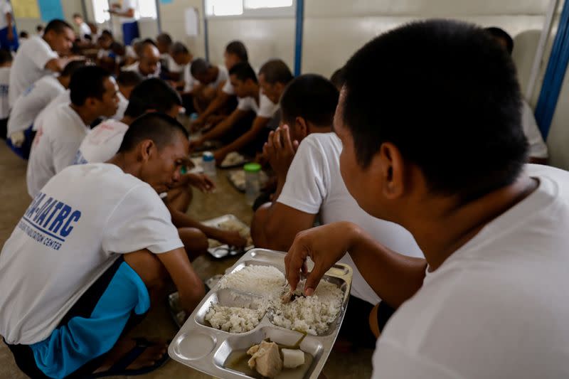 Drug rehab patients eat lunch at the Mega Drug Abuse Treatment and Rehabilitation Center, in Nueva Ecija province, north of Manila