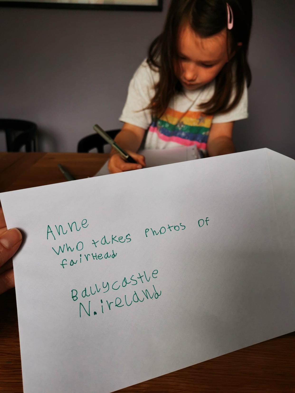 Cora writing her special letter to grandmother Anne Kelly (Anne Kelly/PA)