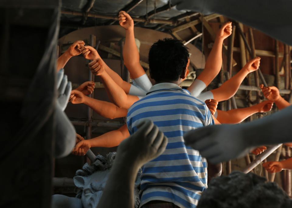 An artist applies paint to an idol of the Hindu goddess Durga at a workshop in New Delhi September 27, 2013. The Durga Puja festival will be celebrated from October 11 to 14, and is the biggest religious event for Bengali Hindus. Hindus believe that the goddess Durga symbolises power and the triumph of good over evil. (REUTERS/Mansi Thapliyal)