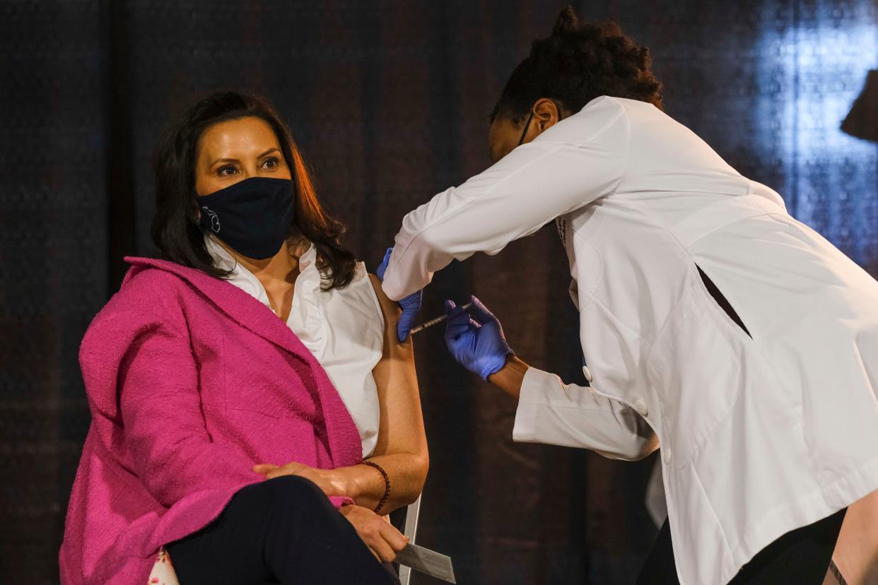 Michigan Gov. Gretchen Whitmer receives a dose of the Pfizer-BioNTech coronavirus vaccine Tuesday in Detroit at an event to promote and encourage Michigan residents to get the vaccine. A surge of new COVID-19 cases is sweeping through the U.S., with Michigan seeing the highest numbers of new infections. (Photo: Matthew Hatcher/Getty Images)