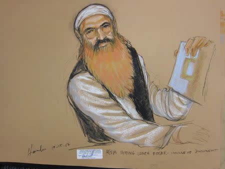 Khalid Sheikh Mohammed holds up a piece of paper in this artist's sketch during a court recess at pre-trail hearing at the U.S. Naval Base Guantanamo Bay, Cuba, October 15, 2012. REUTERS/Janet Hamlin