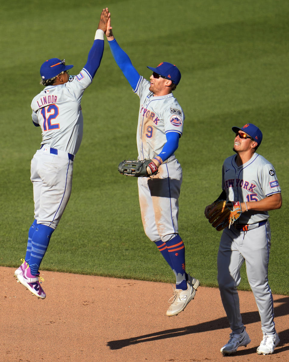 New York Mets' Francisco Lindor (12) and Brandon Nimmo (9) celebrate as Tyrone Taylor (15) watches after the final out of a baseball game against the Pittsburgh Pirates in Pittsburgh, Saturday, July 6, 2024. (AP Photo/Gene J. Puskar)