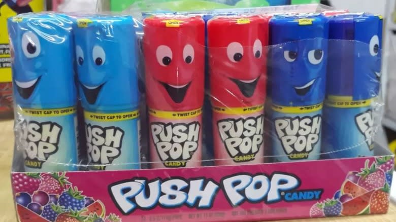 Redesigned modern Push Pop candy packaging with faces in plastic wrap