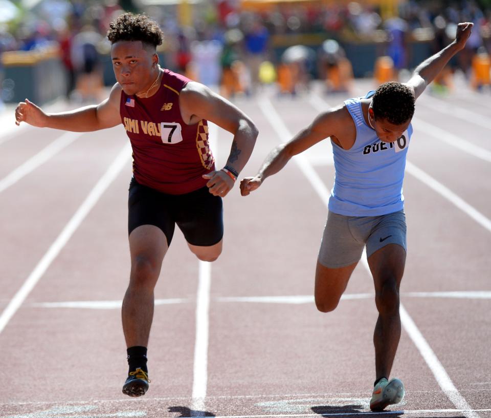 Jaelon Barbarin, left, of Simi Valley and William Boyd of Buena both stretch at the finish line of the Division 2 100-meter dash during the CIF-Southern Section Track and Field Championships at Moorpark High on Saturday, May 14, 2022. Barbarin was second and Boyd took third.