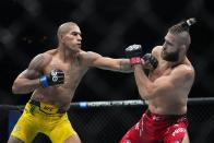 Brazil's Alex Pereira, left, punches Czech Republic's Jirí Procházka during the second round of a light heavyweight title bout at the UFC 295 mixed martial arts event ealry Sunday, Nov. 12, 2023, in New York. (AP Photo/Frank Franklin II)