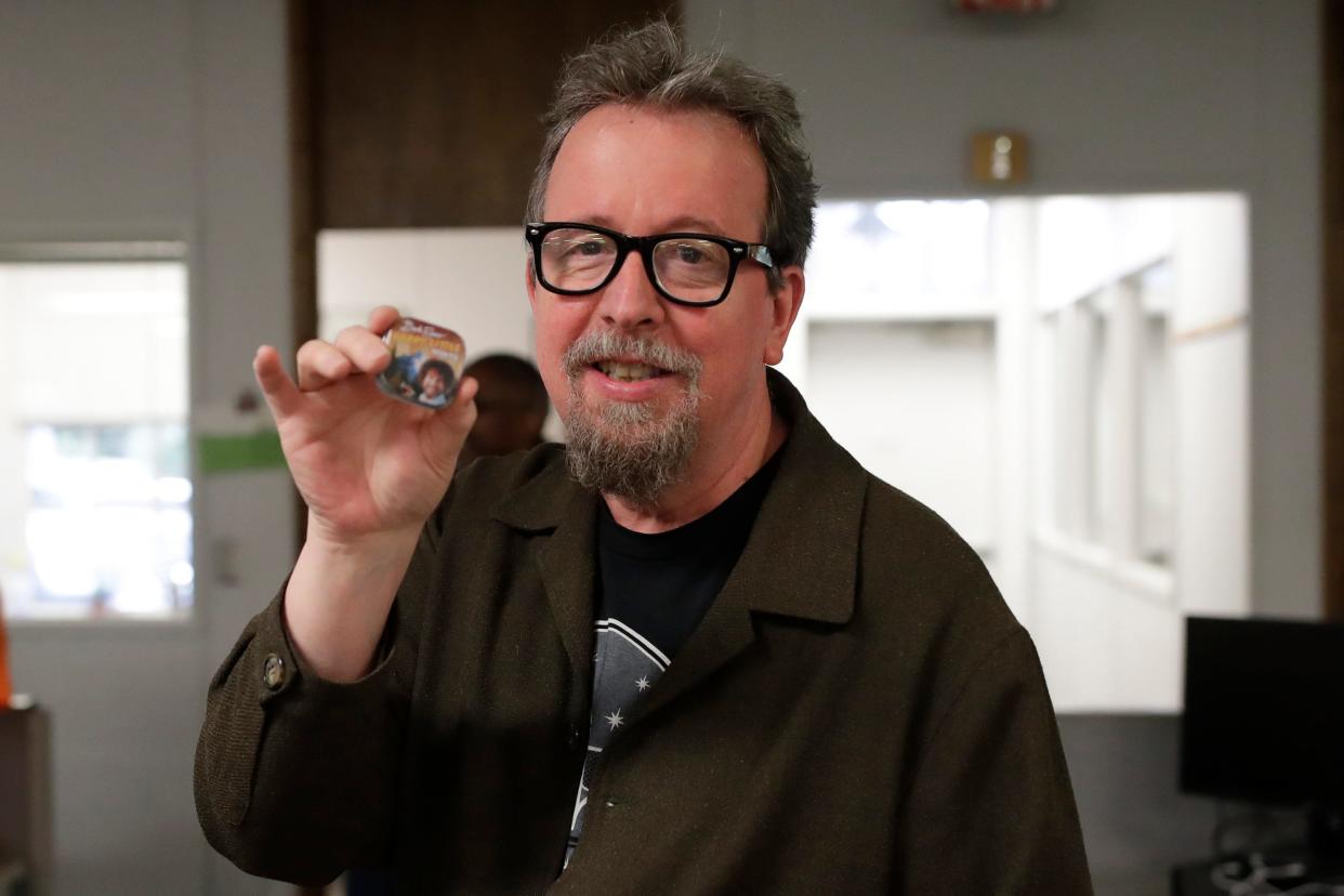 Former Arts and Entertainment Editor Mark Hinson opens gifts from his colleagues on his last day of work at the Tallahassee Democrat Wednesday, Jan. 2, 2019. 