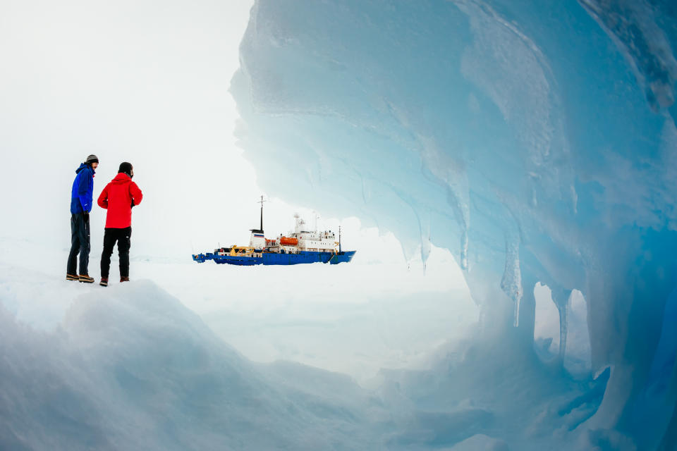 In this Tuesday, Dec. 31, 2013 image provided by Australasian Antarctic Expedition/Footloose Fotography, passengers from the Russian ship MV Akademik Shokalskiy trapped in the ice 1,500 nautical miles south of Hobart, Australia, walk around the ice. Passengers on board a research ship that has been trapped in Antarctic ice for a week are expected to be rescued by helicopter, after three icebreakers failed to reach the paralyzed vessel, officials said Tuesday. (AP Photo/Australasian Antarctic Expedition/Footloose Fotography, Andrew Peacock) EDITORIAL USE ONLY