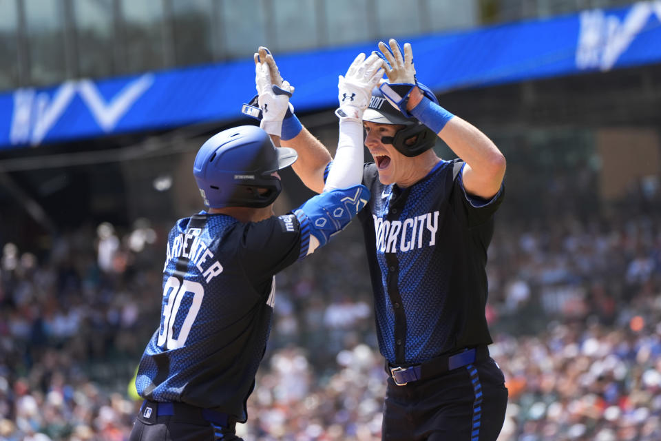 Detroit Tigers' Kerry Carpenter (30) celebrates his two-run home run with Mark Canha against the Toronto Blue Jays in the first inning of a baseball game, Saturday, May 25, 2024, in Detroit. (AP Photo/Paul Sancya)