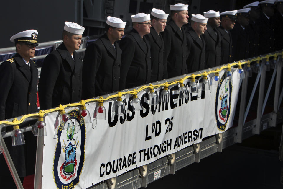 Crew members line the gangplank during a commissioning ceremony for the USS Somerset (LPD 25) Saturday, March 1, 2014, in Philadelphia. The USS Somerset is the ninth San Antonio-class amphibious transport dock and the third of three ships named in honor of those victims and first responders of the attacks on the World Trade Center and the Pentagon. The ship is named for the county where Flight 93 crashed after being hijacked on Sept. 11, 2001. (AP Photo/ Joseph Kaczmarek)