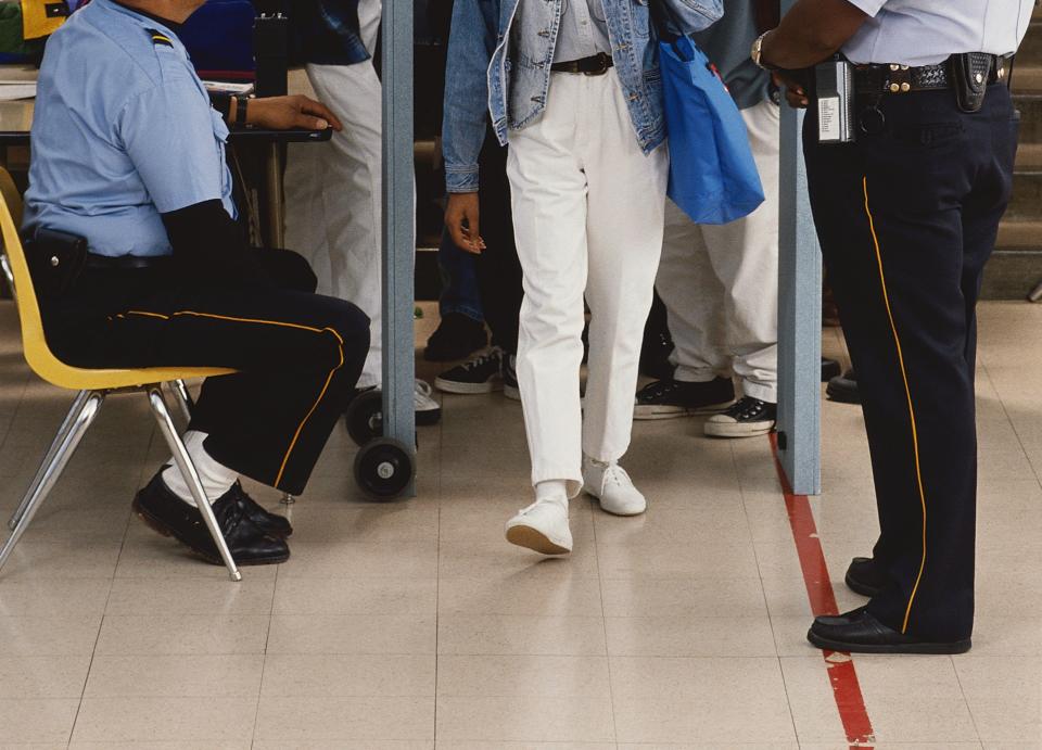 People walking through a metal detector