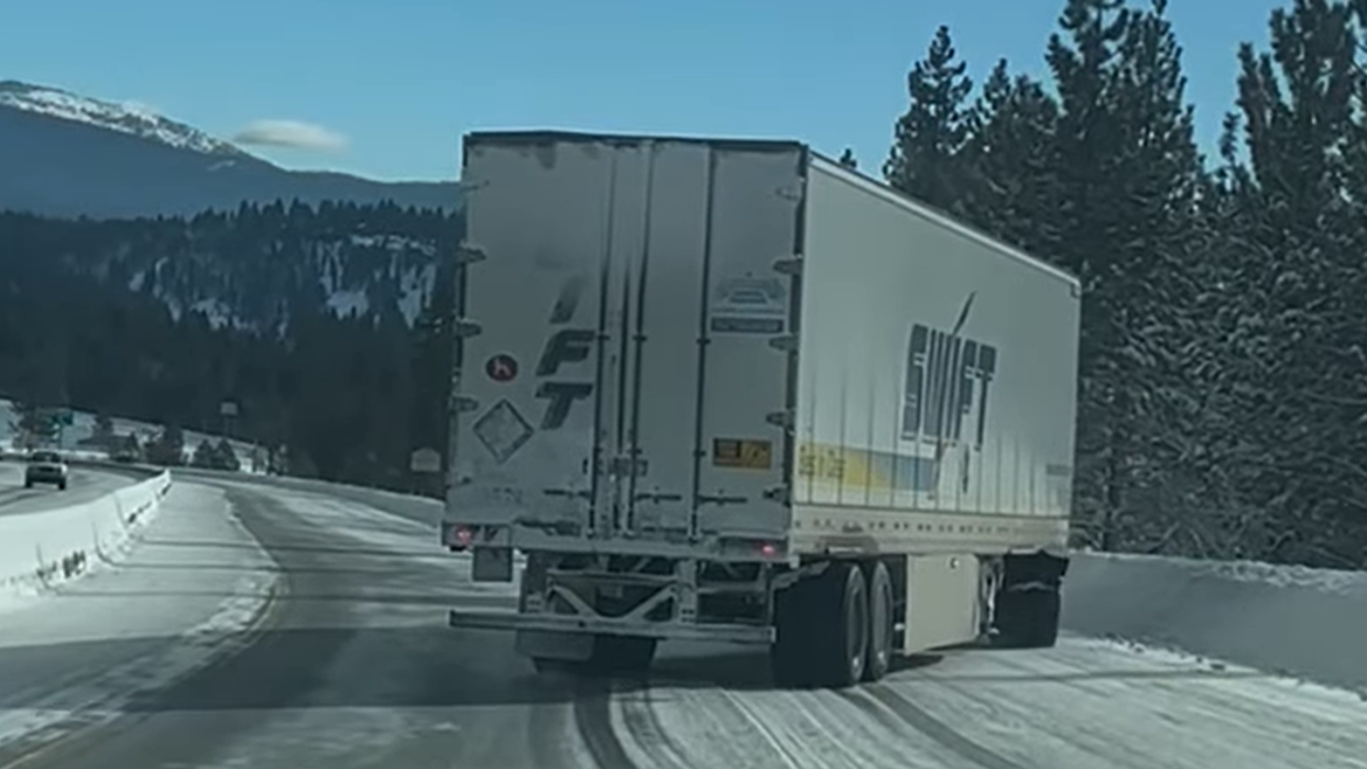 18 wheel commercial truck 'drifting' in the snow along interstate 80 near donner summit in california