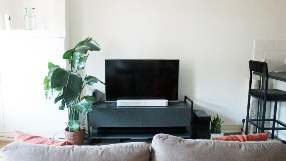 the sonos beam gen 2 soundbar on a tv cabinet under a tv screen