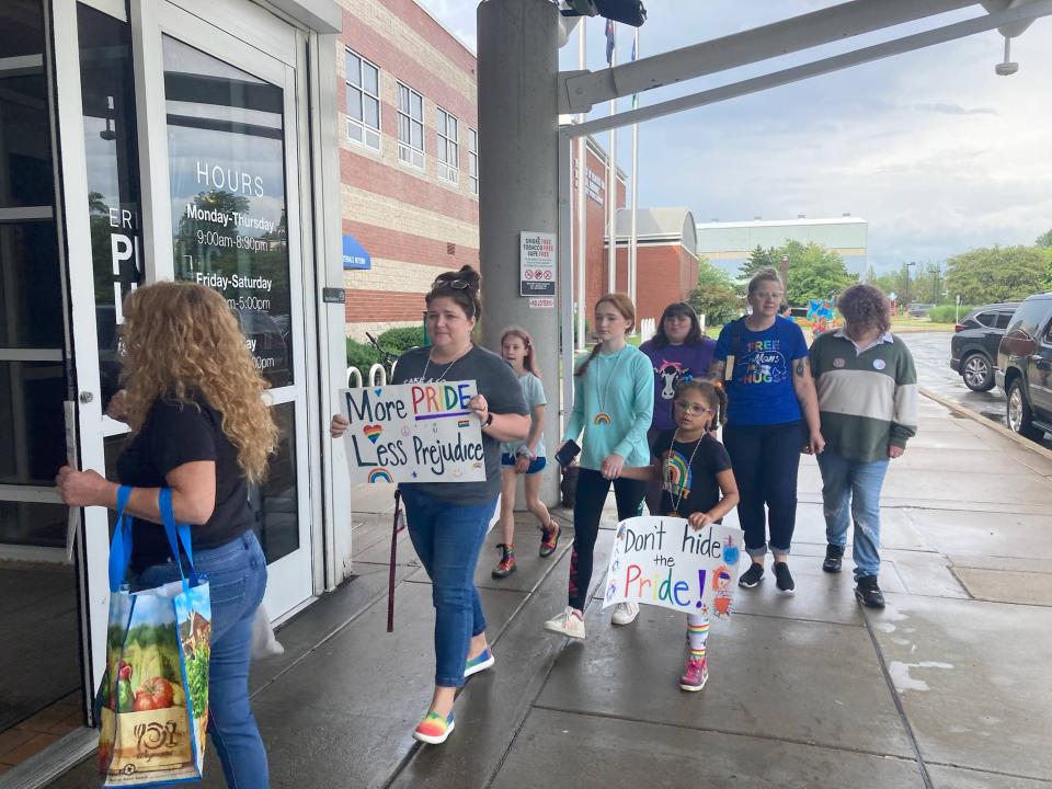 Members of the public enter Blasco Memorial Library on June 26 to participate in a staged "Bring Pride Back" read-in staged inside the children's library.