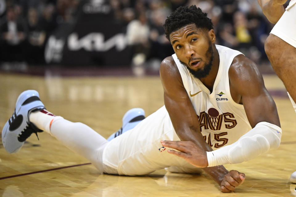Oct 27, 2023; Cleveland, Ohio, USA; Cleveland Cavaliers guard Donovan Mitchell (45) falls to the court in the fourth quarter against the Oklahoma City Thunder at Rocket Mortgage FieldHouse. Mandatory Credit: David Richard-USA TODAY Sports