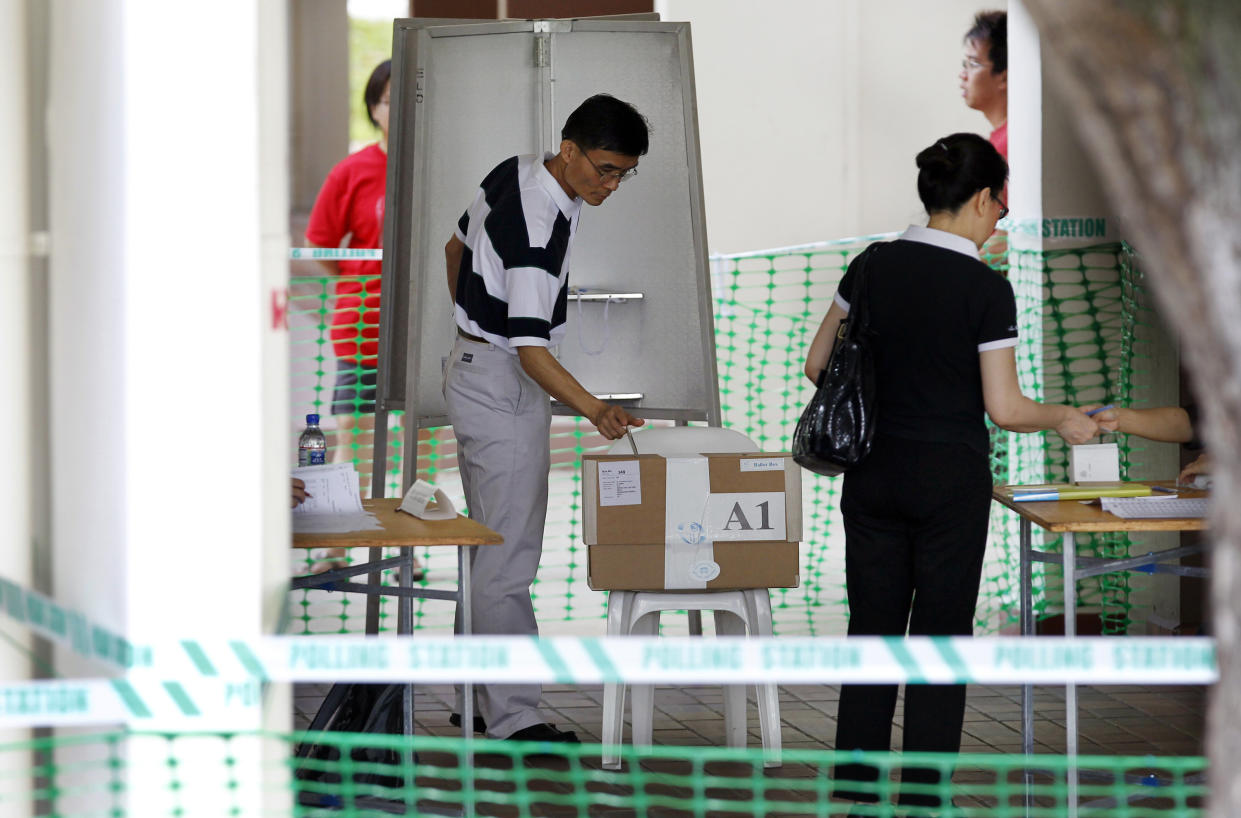Singapore citizens cast their votes at a polling station on Saturday May 7, 2011 in Singapore. Singapore's ruling party faced its toughest challenge since independence in 1965 as voters in the Southeast Asian city-state went to the polls Saturday for parliamentary elections. (AP Photo/Wong Maye-E)