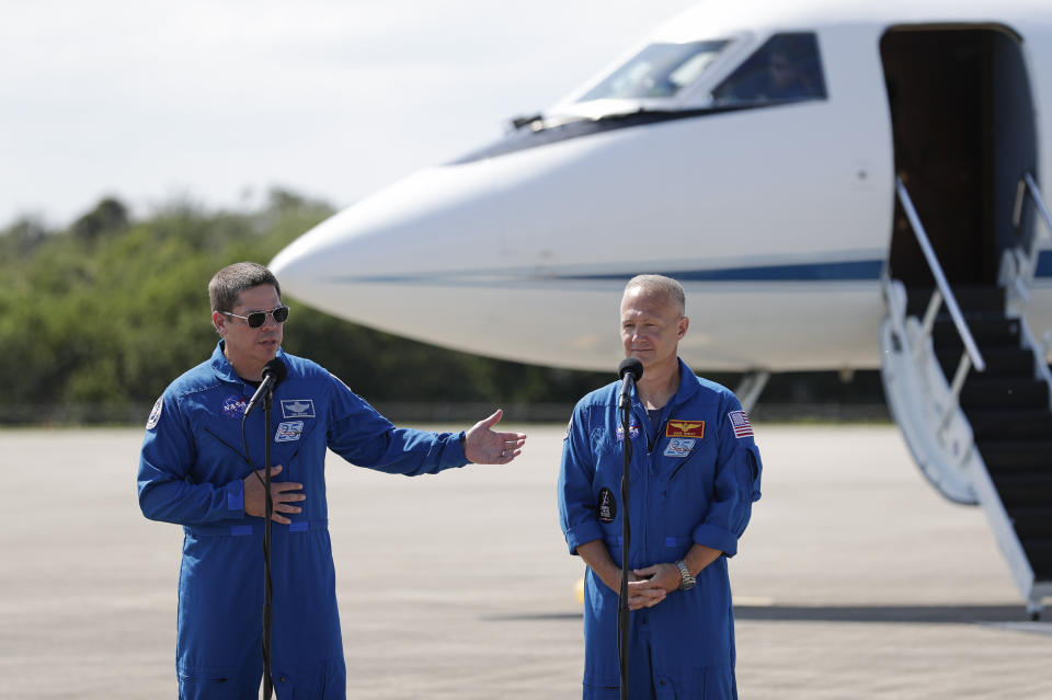 NASA astronauts Robert Behnken , left, and Doug Hurley speak during a news conference after they arrived at the Kennedy Space Center in Cape Canaveral, Fla., Wednesday, May 20, 2020. The two astronauts will fly on the SpaceX Demo-2 mission to the International Space Station scheduled for launch on May 27. (AP Photo/John Raoux)