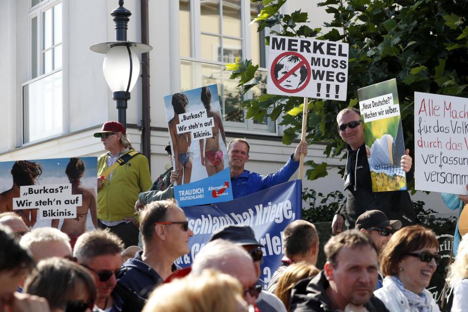 AfD: supporters hold placards reading 'Merkel must go' and 'Burkas? We fancy Bikinis': EPA