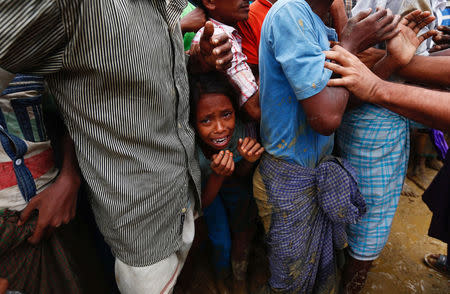 An exhausted Rohingya refugee girl cries as she jostles for aid in Cox's Bazar, Bangladesh September 20, 2017. REUTERS/Danish Siddiqui