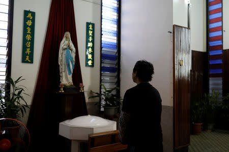 Chen Hong-zhi, 26, who suffers from short-term memory loss, prays at a Catholic church to be helped to find his lost mobile phone, on Beipu Old Street area, in Hsinchu, Taiwan, October 26, 2018. REUTERS/Tyrone Siu