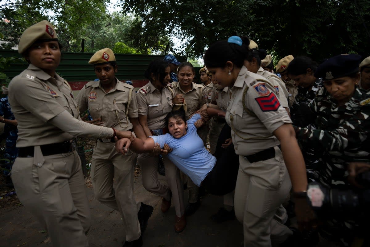 Sakshi Malik, an Indian wrestler who won a bronze medal at the 2016 Summer Olympics, is detained by the police during a protest against Brij Bhushan Sharan Singh, the president of the Wrestling Federation of India, in New Delhi (Copyright 2023 The Associated Press. All rights reserved.)