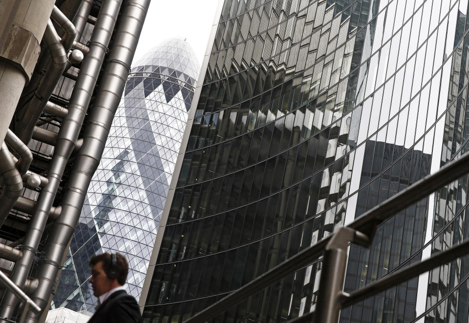 tax cuts  A worker walks past 30 St Mary Axe building, which is known locally as 