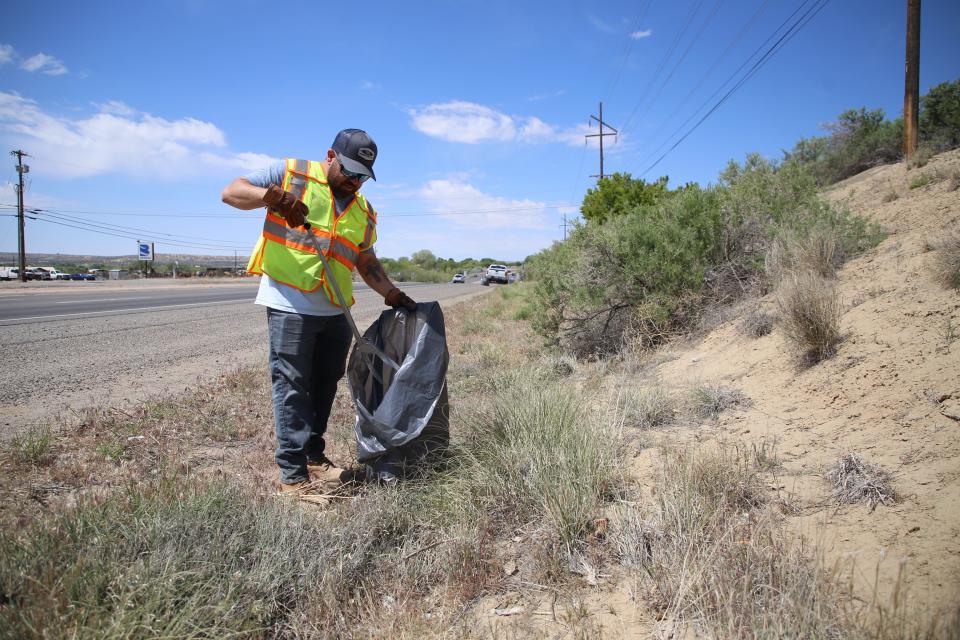 Armand Arellano, the solid waste manager for San Juan County, takes part in a joint cleanup effort along U.S. Highway 64 between Farmington and Bloomfield on Thursday, May 9.