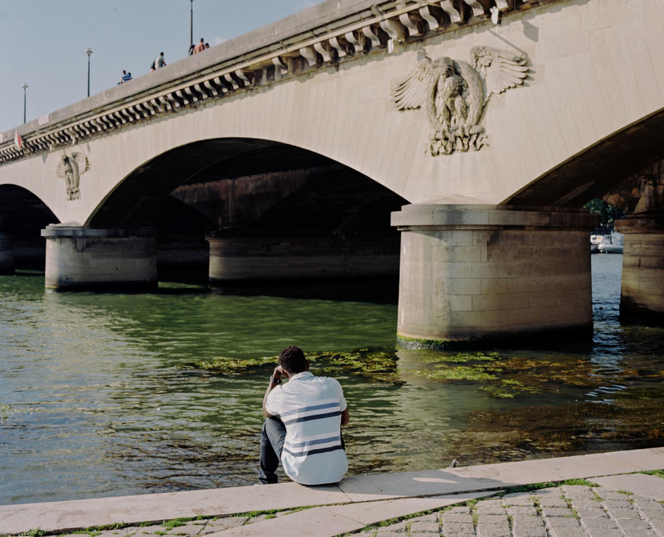 A person sits by the Seine river near the Pont d'Iéna in Paris, France.<span class="copyright">Sasha Arutyunova</span>