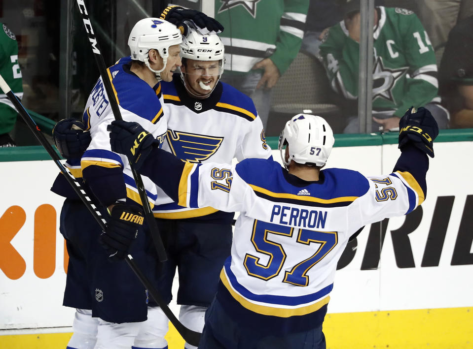 St. Louis Blues' Sammy Blais is congratulated by teammates Jay Bouwmeester, left, and David Perron (57) after scoring during the third period in Game 6 of an NHL second-round hockey playoff series against the Dallas Stars, Sunday, May 5, 2019, in Dallas. The Blues won 4-1. (AP Photo/Tony Gutierrez)