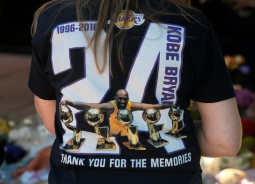 Fans react at a memorial for NBA legend Kobe Bryant outside the Mamba Sports Academy in Thousand Oaks, California on January 27, 2020 after the helicopter crash that killed nine people including Bryant and his daughter Gianna Maria