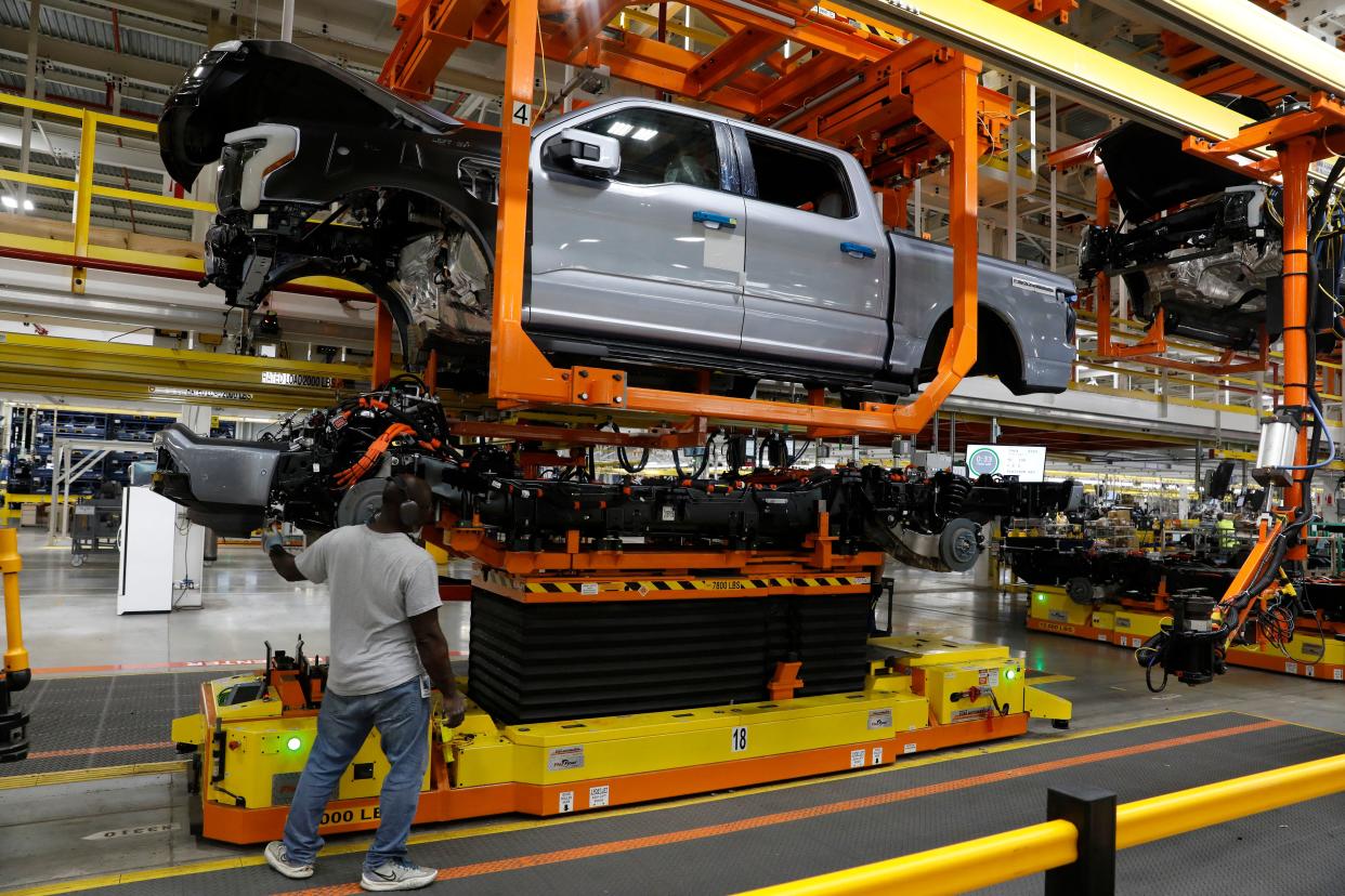 The truck cab is lowered on the frame of Ford Motor Co. battery powered F-150 Lightning trucks under production at their Rouge Electric Vehicle Center in Dearborn, Michigan on September 20, 2022. - Construction crews are back at Dearborn, remaking Ford's century-old industrial complex once again, this time for a post-petroleum era that is finally beginning to feel possible.
The manufacturing operation's prime mission in recent times has been to assemble the best-selling F-150, a gasoline-powered vehicle (Photo by JEFF KOWALSKY / AFP) (Photo by JEFF KOWALSKY/AFP via Getty Images)