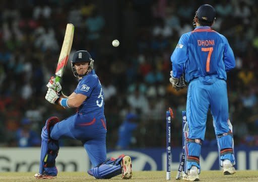 England's Jonathan Bairstow (L) gets dismissed by India spinner Piyush Chawla (not pictured) as wicketkeeper Mahendra Singh Dhoni (R) looks on during their World Twenty20 match on September 23