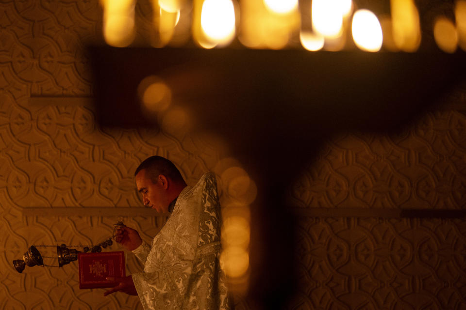 Priest Ivan, chaplain of the 72nd Separate Mechanized Brigade of the Ukrainian army, leads a Christian Orthodox Easter religious service, in Donetsk region, Ukraine, Saturday, May 4, 2024. (AP Photo/Francisco Seco)