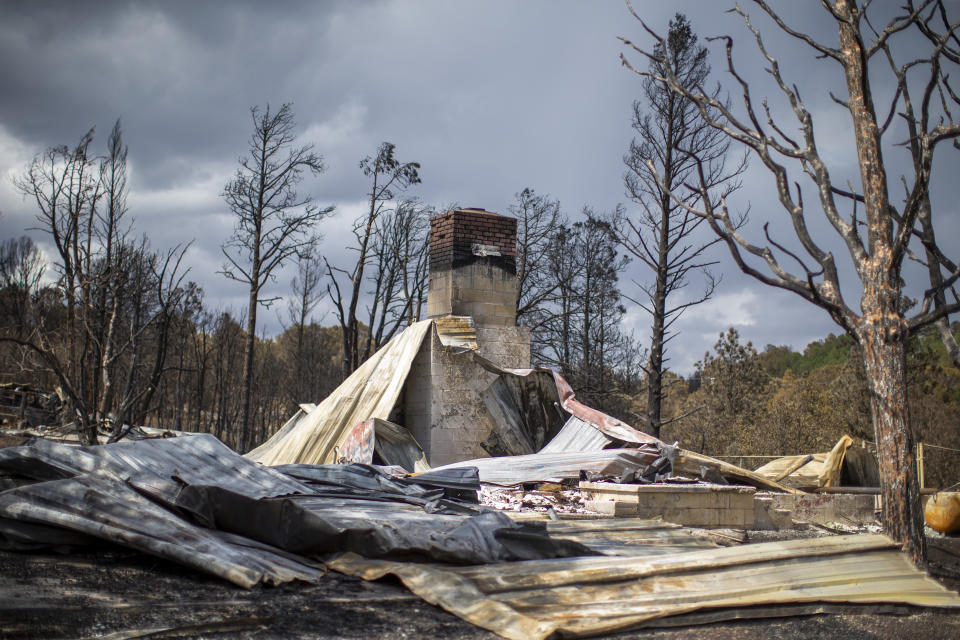 The remains of a house destroyed by the South Fork Fire are pictured in the mountain village of Ruidoso, N.M., Saturday, June 22, 2024. (AP Photo/Andres Leighton)