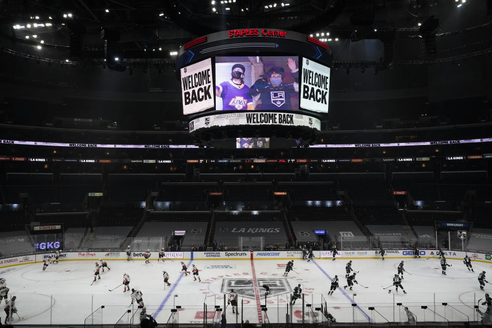 A sign welcomes back fans amid the COVID-19 pandemic as the Los Angeles Kings and Anaheim Ducks warm up before an NHL hockey game Tuesday, April 20, 2021, in Los Angeles. (AP Photo/Marcio Jose Sanchez)