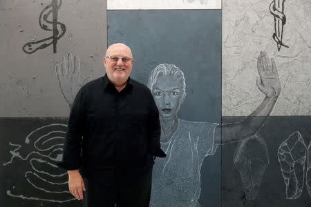 Gallerist Sean Kelly poses in front of "Para Bom Entendedor" (1987) of Portuguese artist Juliao Sarmento during the Art Basel in Basel, Switzerland, June 13, 2018. REUTERS/Moritz Hager