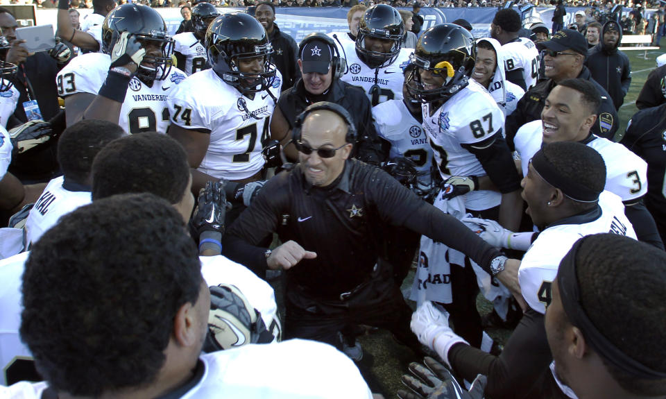 FILE - In this Saturday, Jan. 4, 2014 file photo, Vanderbilt coach James Franklin celebrates with team during the second half of the BBVA Compass Bowl NCAA college football game against Houston in Birmingham, Ala. Franklin hopped back and forth from college to NFL jobs before spending 2008-2010 as Maryland’s offensive coordinator and head-coach-in-waiting. Vanderbilt hired him for the 2011 season. Three winning campaigns later, he landed one of the most prestigious jobs in college sports - head coach of Penn State's football team. (AP Photo/Butch Dill)