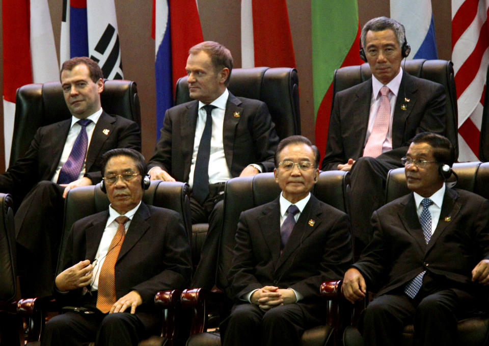 Russia's Prime Minister Dmitry Medvedev, top left, Poland's Prime Minister Donald Tusk, top center, Singapore's Prime Minister Lee Hsien Loong, top right, Laos' President Choummaly Sayasone, bottom left, China's Premier Wen Jiabao, bottom center, and Cambodia's Prime Minister Hun Sen take part in the opening ceremony for the ASEM Summit in Vientiane, Laos, Monday, Nov. 5, 2012. (AP Photo/Sakchai Lalit)